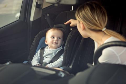 Portrait of mother and baby boy sitting in car on front seats; Shutterstock ID 663375574; purchase_order: aljazeera ; job: ; client: ; other: