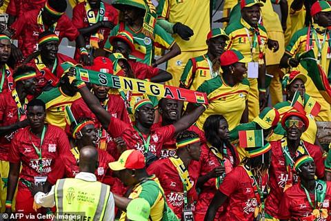 Senegal s supporters wave during the Africa Cup of Nations (CAN) 2024 group C football match between Senegal and Gambia at Stade Charles Konan Banny in Yamoussoukro on January 15, 2024. (Photo by Issouf SANOGO / AFP) (Photo by ISSOUF SANOGO/AFP via Getty Images)