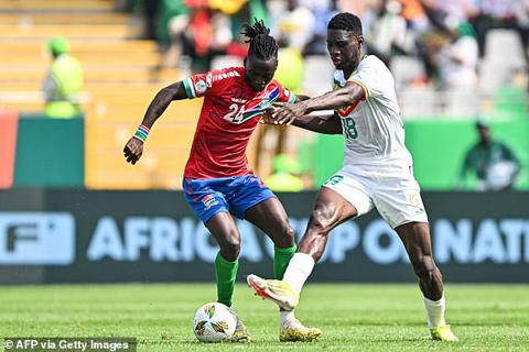 Senegal s forward #18 Ismaila Sarr (R) fights for the ball with Gambia s midfielder #24 Ebrima Darboe during the Africa Cup of Nations (CAN) 2024 group C football match between Senegal and Gambia at Stade Charles Konan Banny in Yamoussoukro on January 15, 2024. (Photo by Issouf SANOGO / AFP) (Photo by ISSOUF SANOGO/AFP via Getty Images)