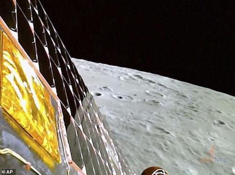 This image from video provided by the Indian Space Research Organisation shows the surface of the moon as the Chandrayaan-3 spacecraft prepares for landing on Wednesday. Its golden insulating material and solar panels are visible