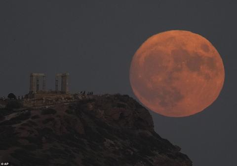 GREECE: The supermoon rises behind the ancient temple of Poseidon at Cape Sounion, about 70 kilometers (45 miles) south of Athens