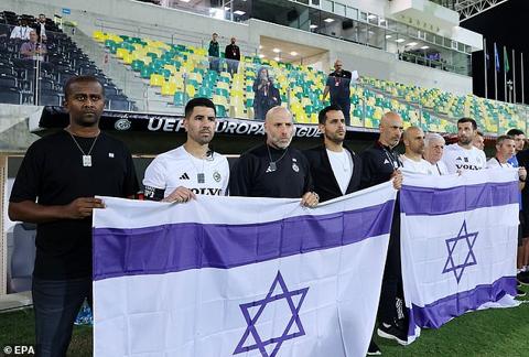 Maccabi Haifa s bench showed the Israeli flag during the minute s silence to honour victims