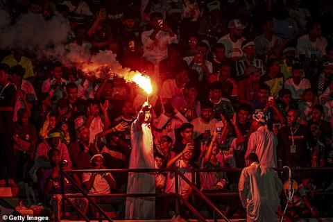 Fans light a flare during the Saudi Legends and World Legends match at Al Ahli Sports Club