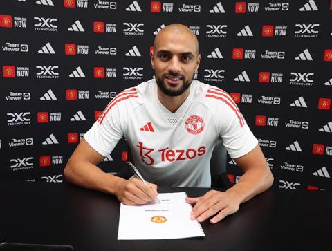 Sofyan Amrabat signs his United contract at Carrington.