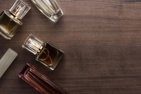 different perfume bottles on the wooden background
