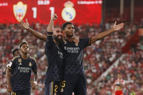 Real Madrid s Jude Bellingham, right, celebrates with Dani Carvajal after scoring his side s second goal during a Spanish La Liga soccer match between Almeria and Real Madrid at the Power Horse Stadium in Almeria, Spain, Saturday, Aug. 19, 2023. (AP Photo/Fermin Rodriguez)