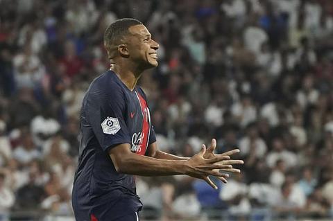 PSG s Kylian Mbappe celebrates after scoring his side s fourth goal during the French League One soccer match between Lyon and Paris Saint-Germain at the Groupama stadium, outside Lyon, France, Sunday, Sept. 3, 2023. (AP Photo/Laurent Cipriani)