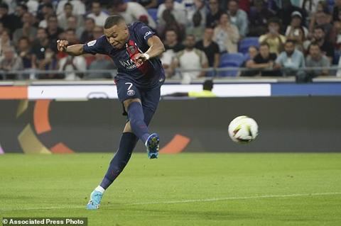 PSG s Kylian Mbappe shoots on target during the French League One soccer match between Lyon and Paris Saint-Germain at the Groupama stadium, outside Lyon, France, Sunday, Sept. 3, 2023. (AP Photo/Laurent Cipriani)