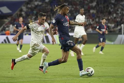 PSG s Bradley Barcola, centre, and Lyon s Nicolas Tagliafico challenge for the ball during the French League One soccer match between Lyon and Paris Saint-Germain at the Groupama stadium, outside Lyon, France, Sunday, Sept. 3, 2023. (AP Photo/Laurent Cipriani)