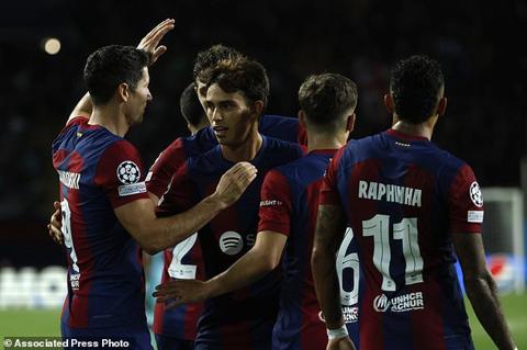 Barcelona s Joao Felix, second left, celebrates with his teammate Robert Lewandowski after scoring his side s opening goal during the Champions League Group H soccer match between Barcelona and Royal Antwerp at the Olympic Stadium of Montjuic in Barcelona, Spain, Tuesday, Sept. 19, 2023. (AP Photo/Joan Monfort)