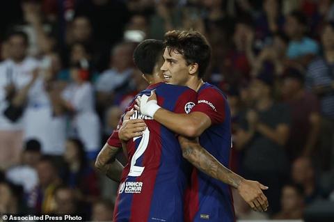 Barcelona s Joao Felix, right, celebrates with his teammate Joao Cancelo after scoring his side s fifth goal during the Champions League Group H soccer match between Barcelona and Royal Antwerp at the Olympic Stadium of Montjuic in Barcelona, Spain, Tuesday, Sept. 19, 2023. (AP Photo/Joan Monfort)