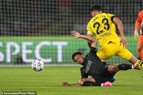 PSG s Warren Zaire-Emery, bottom, is challenged by Dortmund s Emre Can during the Champions League group F soccer match between Paris Saint-Germain and Borussia Dortmund, at the Parc des Princes stadium in Paris, France, Tuesday, Sept. 19, 2023. (AP Photo/Michel Euler)