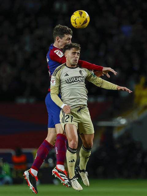 Granada s Oscar Melendo, front, and Barcelona s Andreas Christensen fight for the ball during the Spanish La Liga soccer match between Barcelona and Granada at the Olimpic Lluis Companys stadium in Barcelona, Spain, Sunday, Feb. 11, 2024. (AP Photo/Joan Monfort)