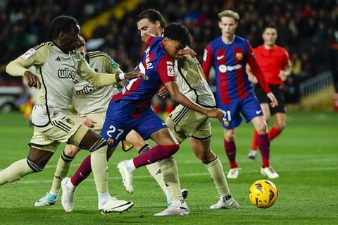 Barcelona s Lamine Yamal fights for the ball during the Spanish La Liga soccer match between Barcelona and Granada at the Olimpic Lluis Companys stadium in Barcelona, Spain, Sunday, Feb. 11, 2024. (AP Photo/Joan Monfort)