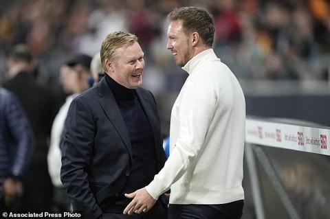 Netherlands head coach Ronald Koeman, left, talks to Germany s head coach Julian Nagelsmann prior the start of the international friendly soccer match between Germany and Netherlands at the Deutsche Bank Park in Frankfurt, Germany on Tuesday, March 26, 2024. (AP Photo/Martin Meissner)
