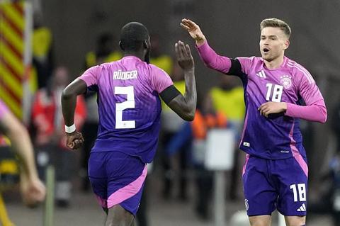 Germany s Maximilian Mittelstadt, right, celebrates with Germany s Antonio Rudiger after scoring his sides first goal Netherlands goalkeeper Bart Verbruggen fails to make a save during the international friendly soccer match between Germany and Netherlands at the Deutsche Bank Park in Frankfurt, Germany on Tuesday, March 26, 2024. (AP Photo/Martin Meissner)
