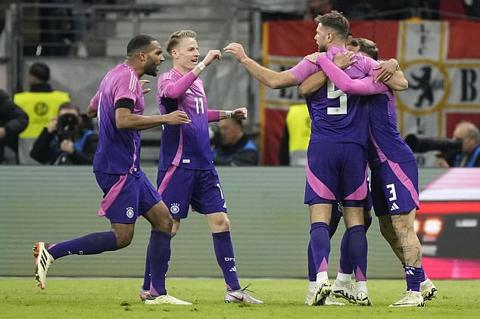 Germany s Niclas Fullkrug celebrates with teammates after scoring his sides second goal during the international friendly soccer match between Germany and Netherlands at the Deutsche Bank Park in Frankfurt, Germany on Tuesday, March 26, 2024. (AP Photo/Martin Meissner)