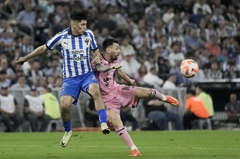 Inter Miami s Lionel Messi, right, attempts a shot on goal challenged by Monterrey s Gerardo Arteaga during a CONCACAF Champions Cup quarter final second leg soccer match at the BBVA stadium in Monterrey, Mexico, Wednesday, April 10, 2024. (AP Photo/Eduardo Verdugo)