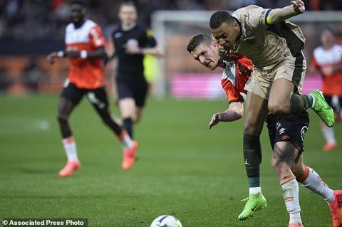 PSG s Kylian Mbappe, right, and Lorient s Panos Katseris vie for the ball during the French League One soccer match between Lorient and Paris Saint-Germain at the Moustoir stadium in Lorient, Brittany, western France, Wednesday, April 24, 2024. (AP Photo/Michel Euler)