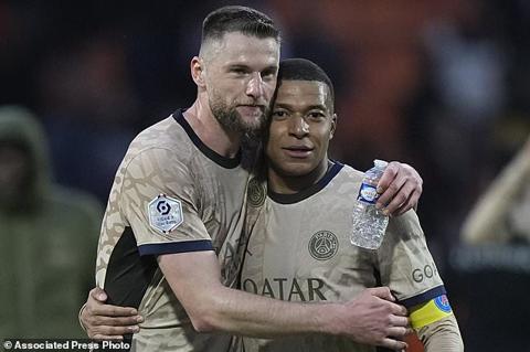 PSG s Milan Skriniar, left, hugs Kylian Mbappe after winning the French League One soccer match between Lorient and Paris Saint-Germain at the Moustoir stadium in Lorient, Brittany, western France, Wednesday, April 24, 2024. (AP Photo/Michel Euler)